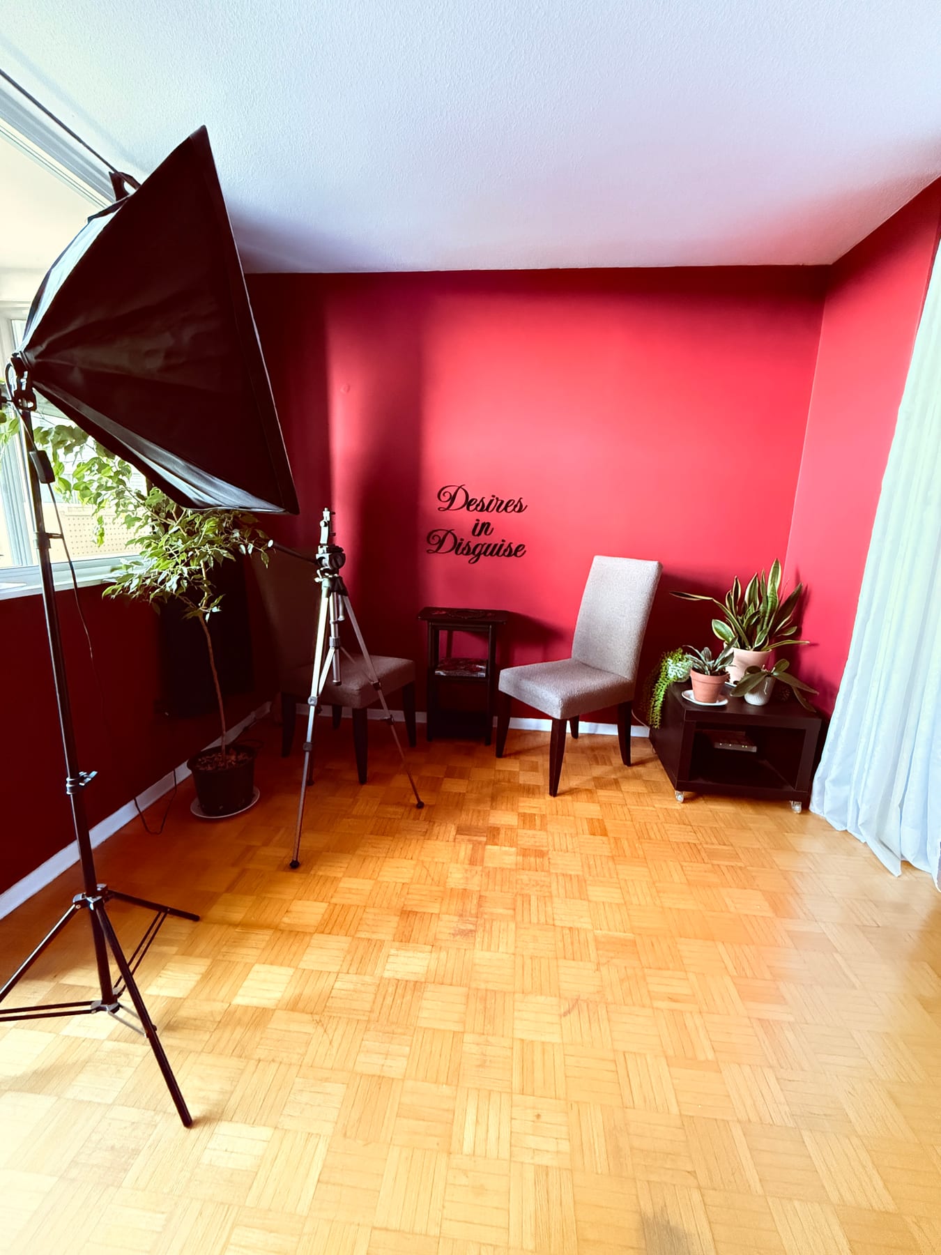 The private apartment studio in Toronto — deep red walls and warm light
